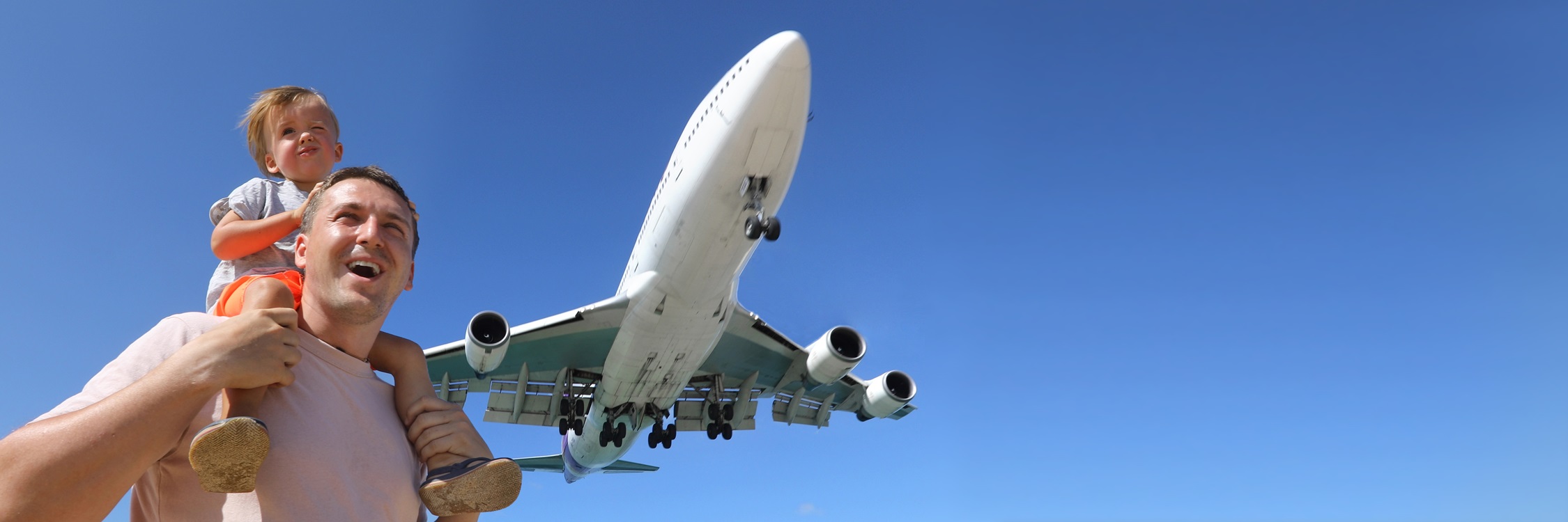 ather and son watching the landing plane